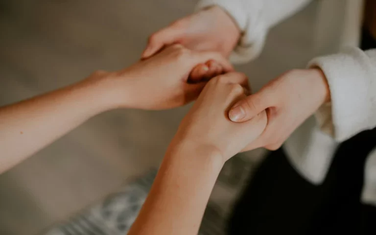 Supportive hands holding, illustrating stress management techniques for thyroid health.