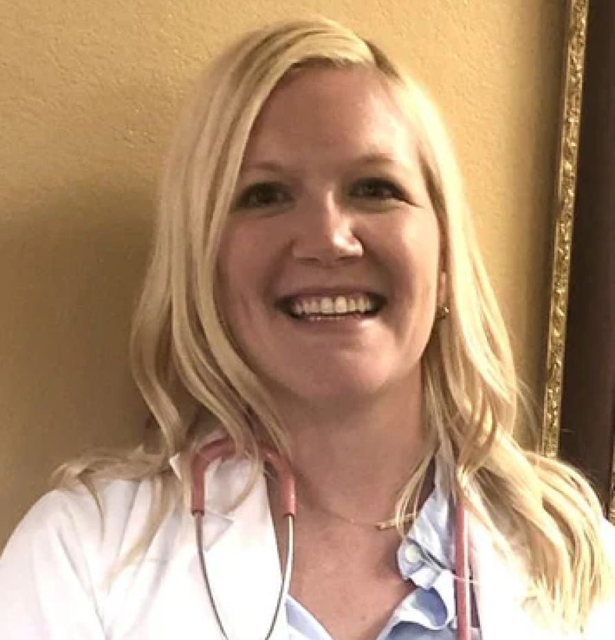 Smiling woman in a white coat with a stethoscope, representing a healthcare professional, reflecting holistic health and wellness expertise.