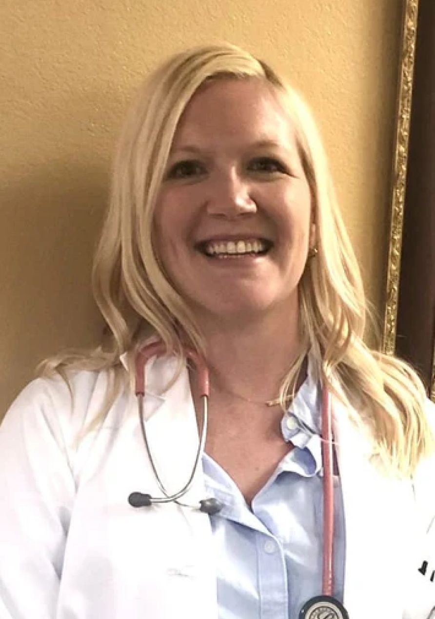 Christina Cadden, Family Nurse Practitioner and registered nurse, smiling and wearing a stethoscope.
