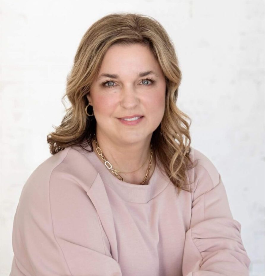 Tiffany Flaten, founder of Rock Bottom Wellness, smiling in a soft pink sweater, promoting holistic health and wellness, emphasizing functional nutrition and personal health journeys.