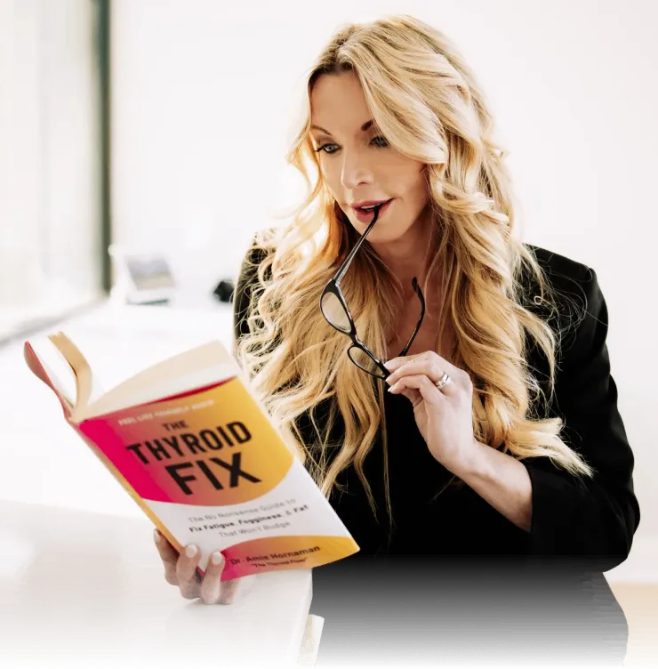 Dr. Amie Hornaman holding The Thyroid Fix book, thyroid health solutions for women.